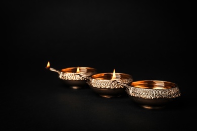 Diwali diyas or clay lamps on dark background