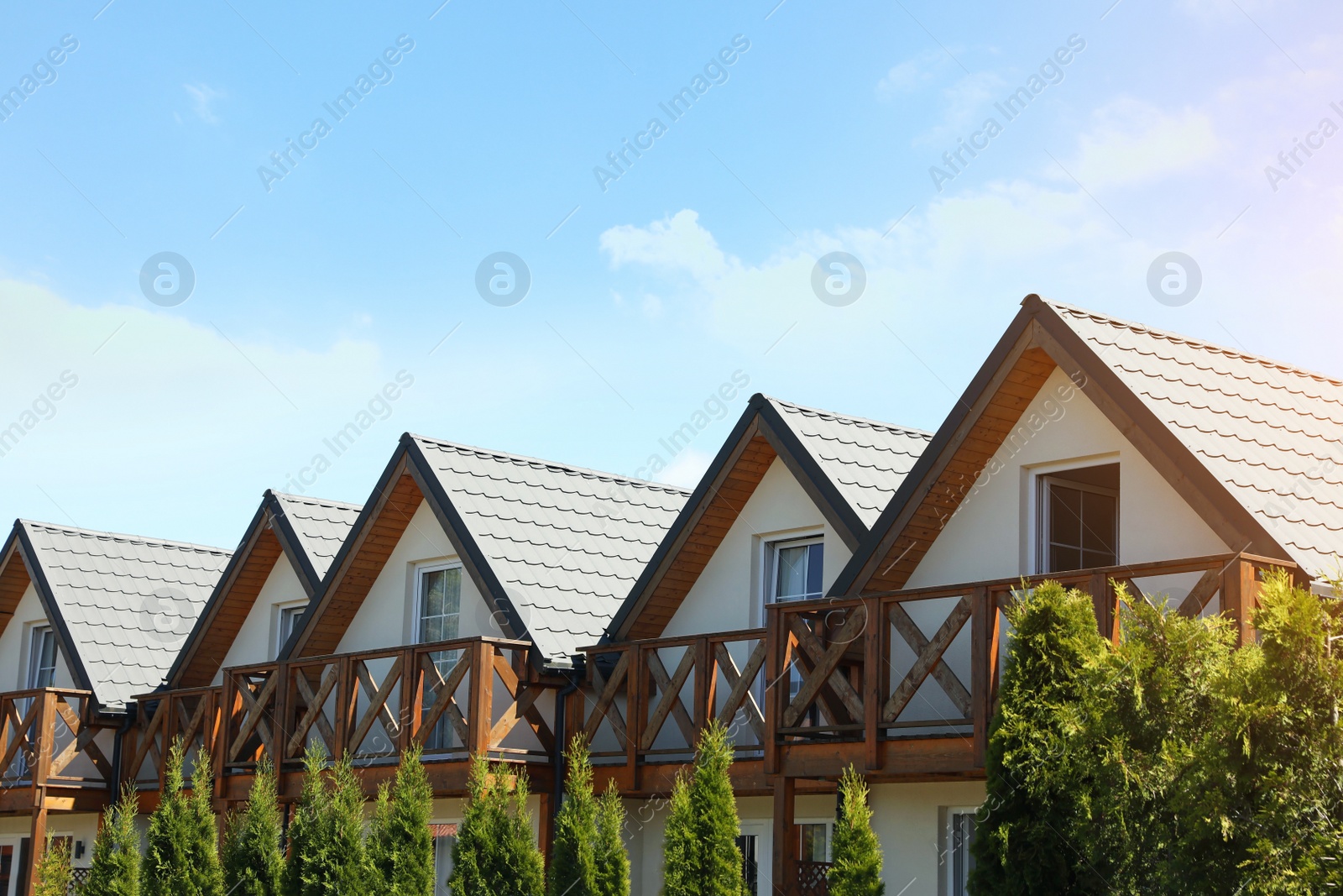 Photo of Exterior of beautiful houses with balconies against blue sky