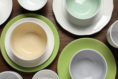 Photo of Beautiful ceramic dishware on wooden table, flat lay