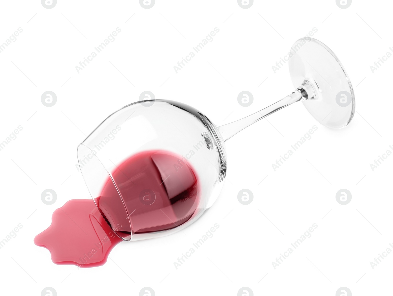 Photo of Overturned glass and spilled wine on white background