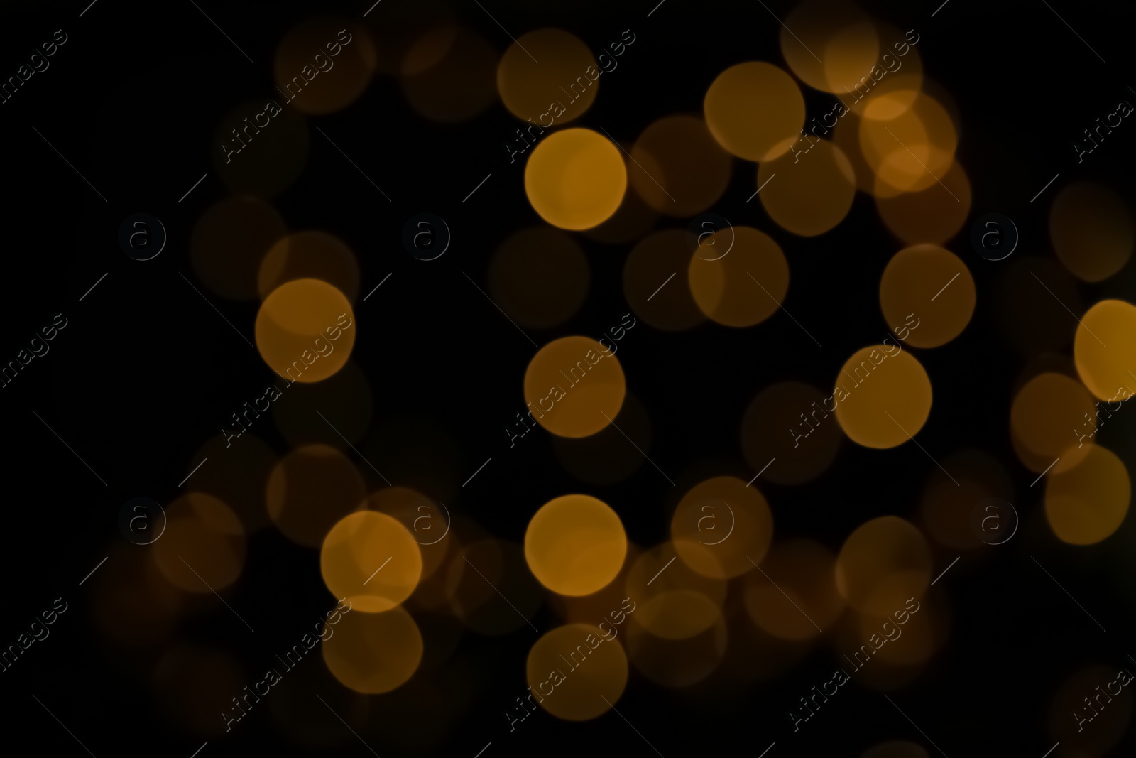 Photo of Blurred view of beautiful lights on black background. Bokeh effect