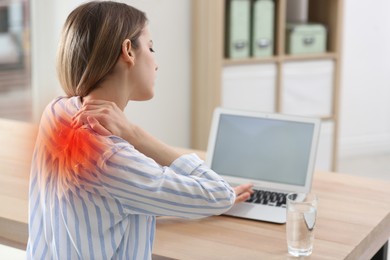 Woman suffering from neck pain in office. Symptom of bad posture