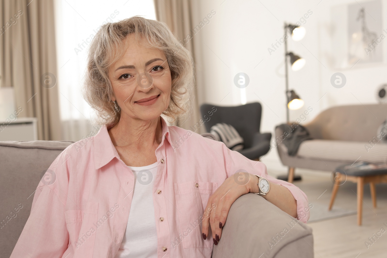 Photo of Portrait of mature woman in living room