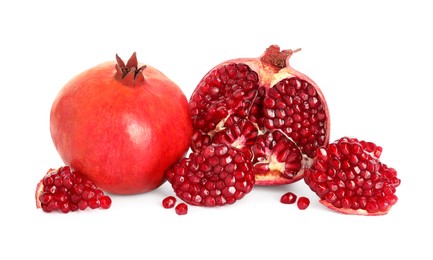 Photo of Half and whole pomegranates isolated on white