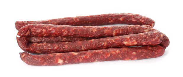 Photo of Thin dry smoked sausages isolated on white