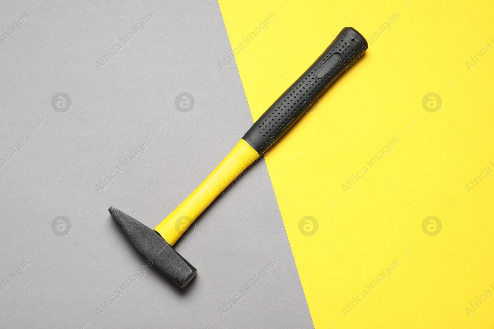 Photo of New hammer with rubber handle on color background