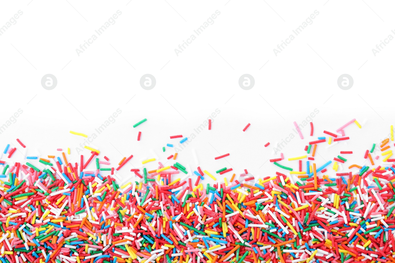 Photo of Colorful sprinkles on white background, top view. Confectionery decor