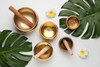 Photo of Flat lay composition with golden singing bowls on white background