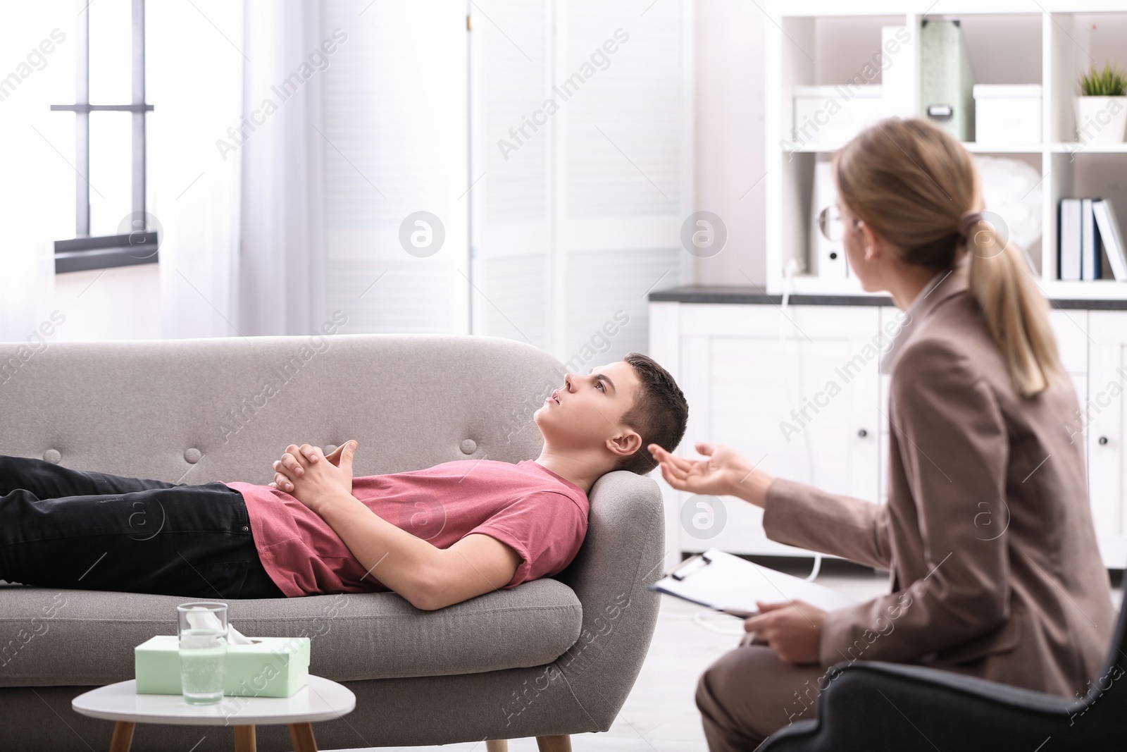 Photo of Psychotherapist working with young man in office