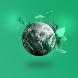 Image of Recycling concept. Earth planet with leaves on color background