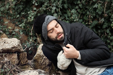 Photo of Poor homeless man on street in city