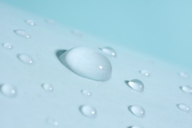 Photo of Macro photo of water drops on light blue background
