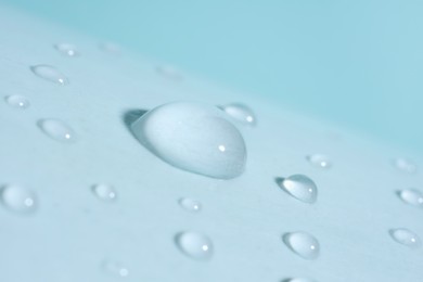 Macro photo of water drops on light blue background