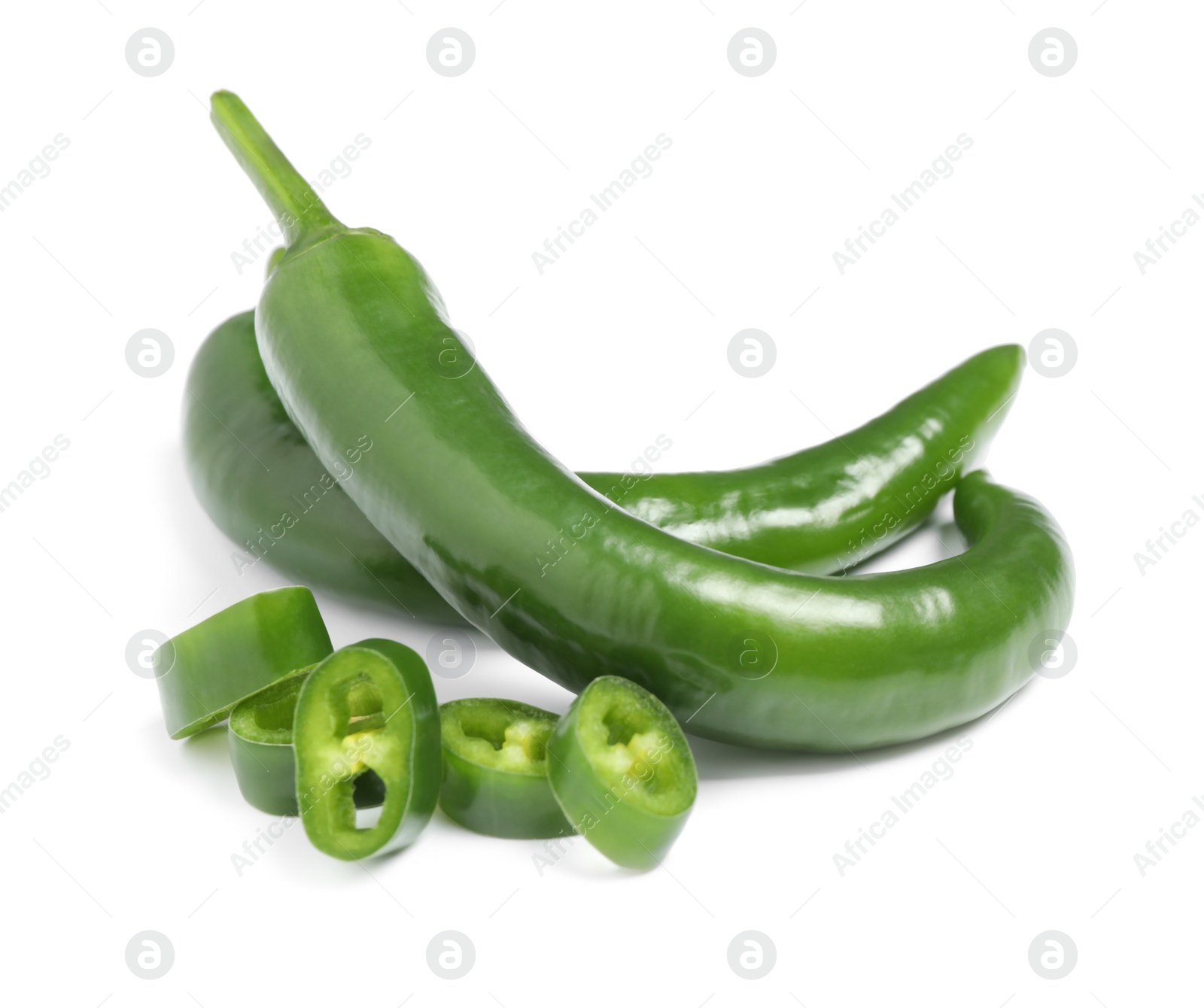 Photo of Cut and whole green hot chili peppers on white background