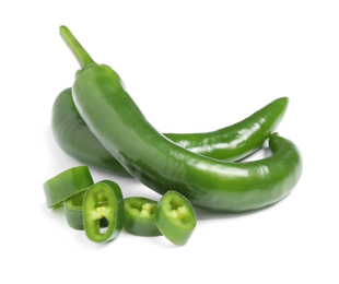 Photo of Cut and whole green hot chili peppers on white background