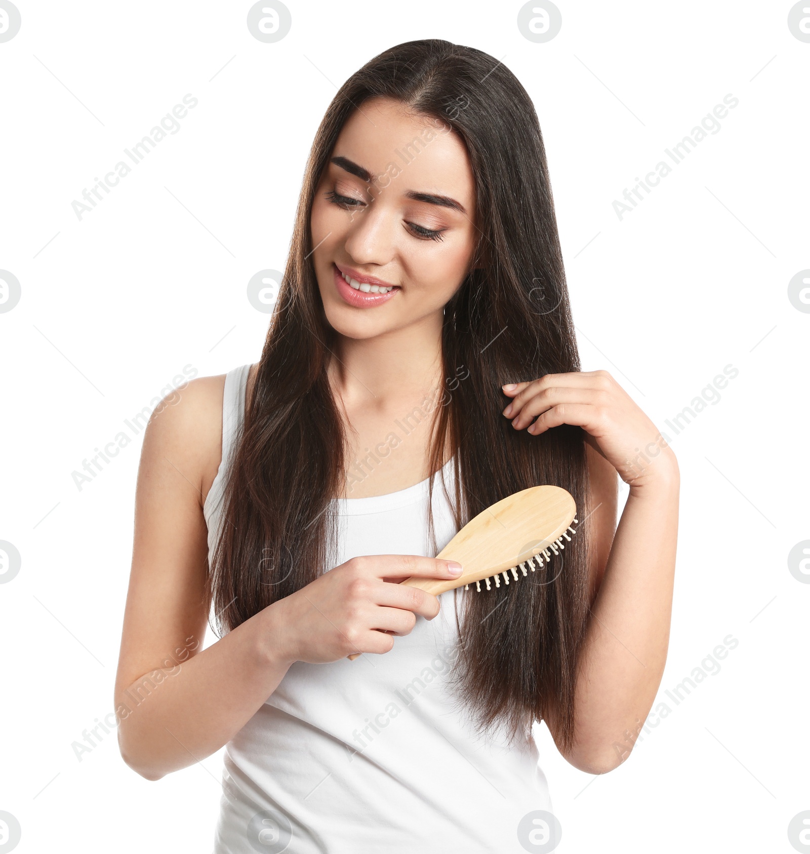 Photo of Beautiful young woman with hair brush on white background