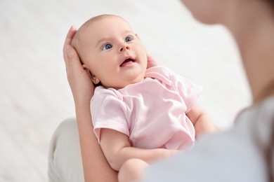 Mother with her cute little baby at home