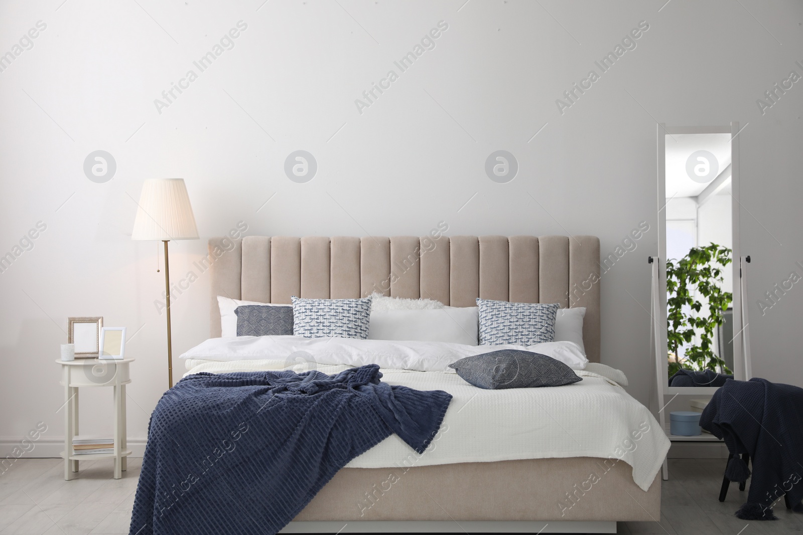 Photo of Comfortable bed with pillows in room. Stylish interior design