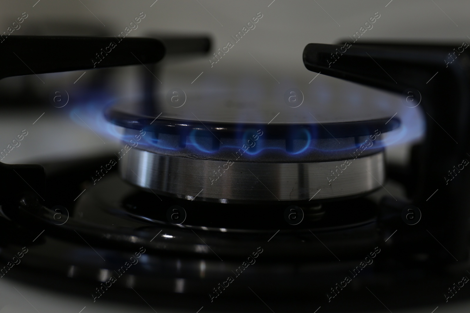 Photo of Modern kitchen stove with burning gas, closeup