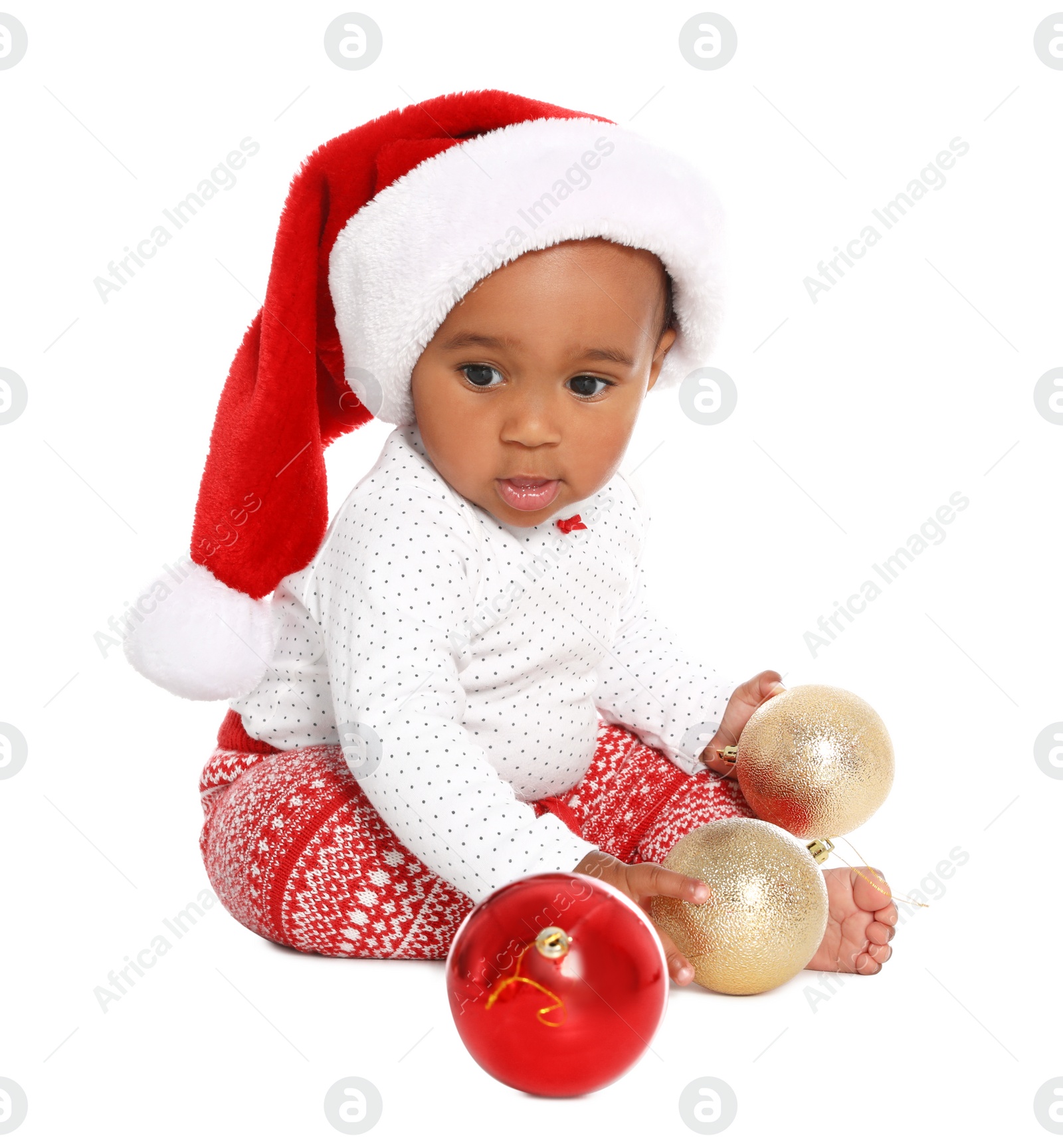 Photo of Festively dressed African-American baby with Christmas decorations on white background