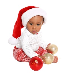 Photo of Festively dressed African-American baby with Christmas decorations on white background