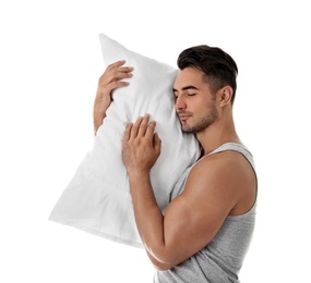 Young man with soft pillow on white background