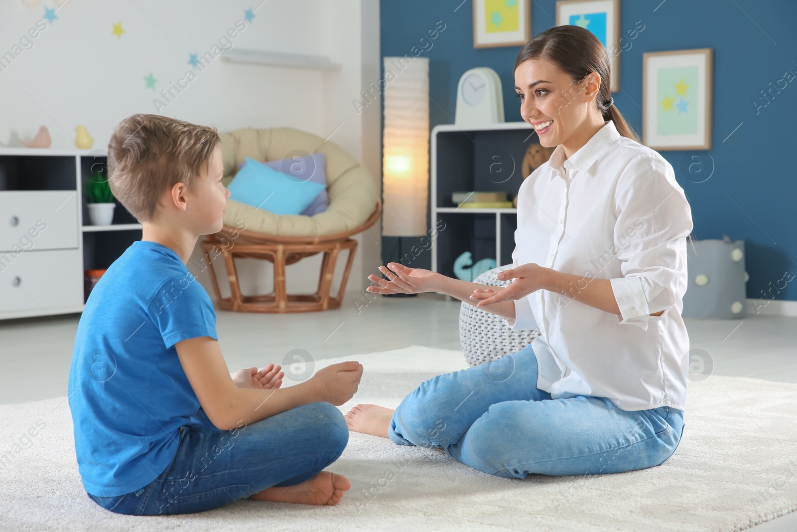 Photo of Female psychologist working with cute little boy in office