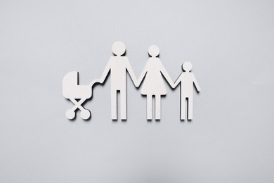 Figures of family on light background, top view. Insurance concept