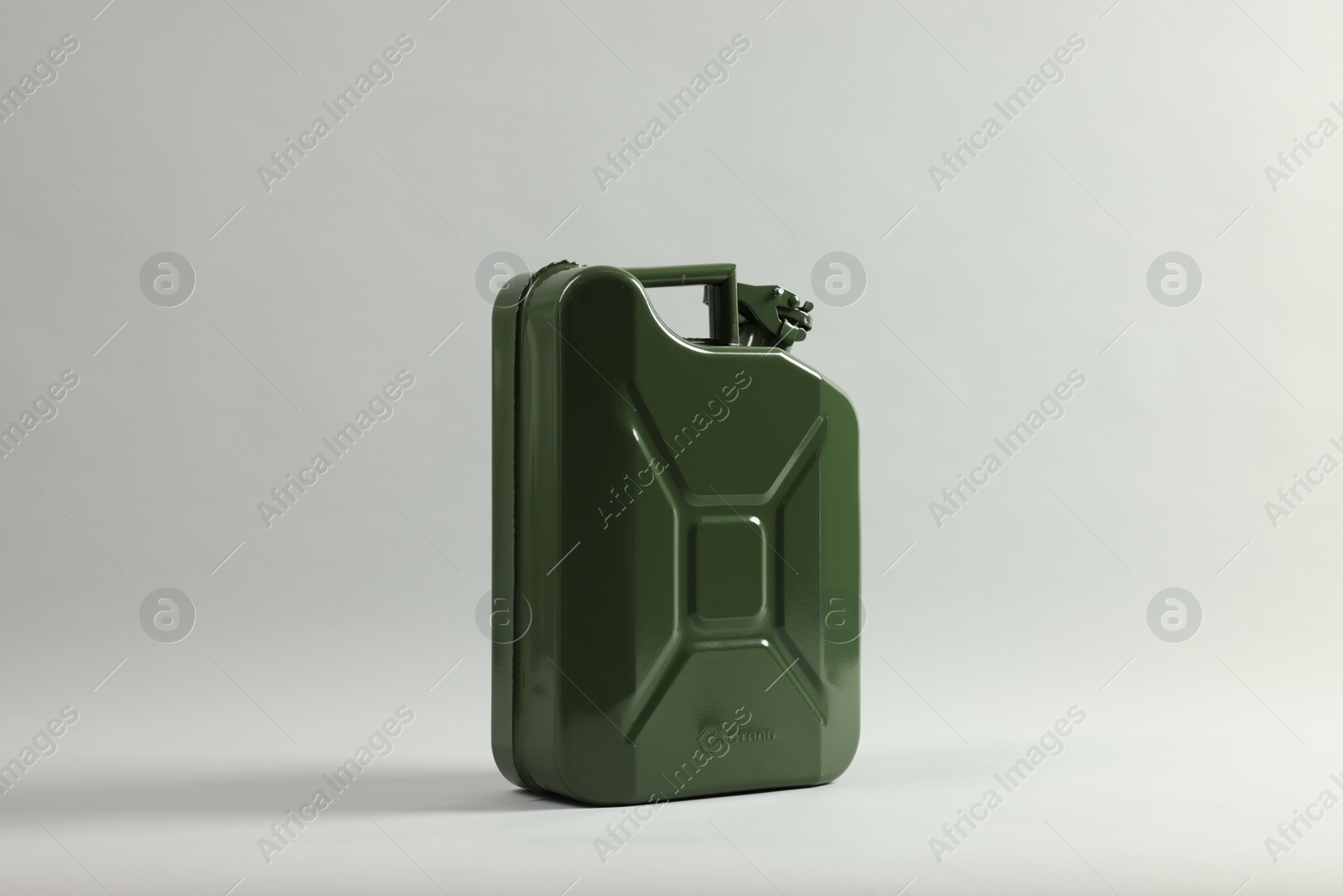 Photo of Green metal canister on light grey background