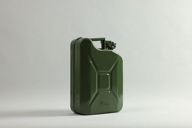 Green metal canister on light grey background