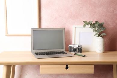 Photo of Cozy blogger workplace with laptop at home