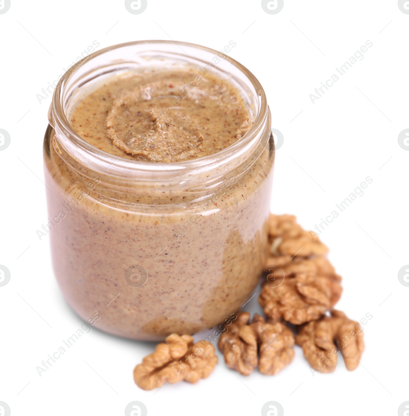 Photo of Tasty nut paste in jar and walnuts isolated on white