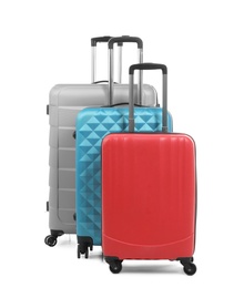 Photo of New suitcases packed for journey on white background