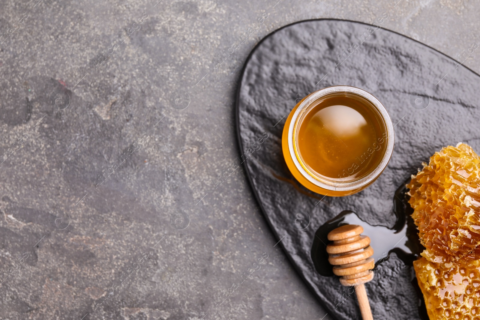 Photo of Tasty aromatic honey grey table, flat lay. Space for text