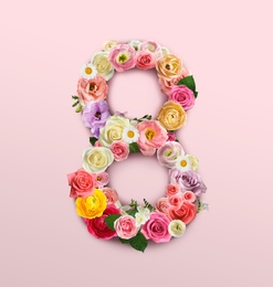 Image of International women's day. Number 8 made of beautiful flowers on pale pink background, top view