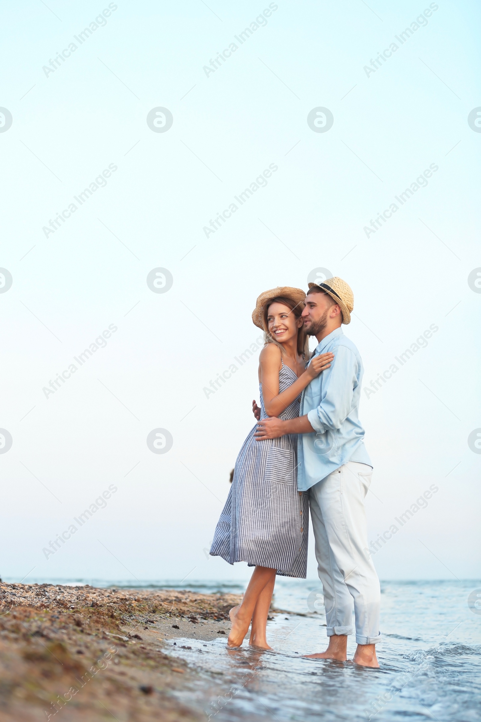 Photo of Young couple spending time together on beach
