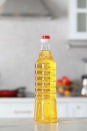 Bottle of cooking oil on white marble table in kitchen