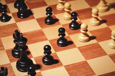 Photo of Wooden chessboard with game pieces as background