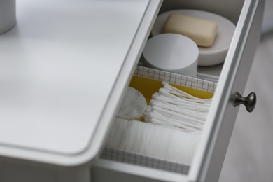 Photo of Open drawer with cotton buds and pads indoors , above view