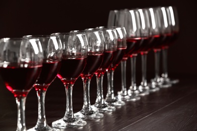 Glasses with delicious red wine on table