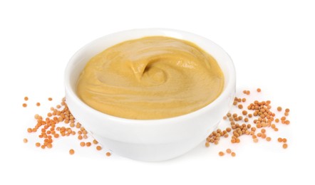 Photo of Fresh tasty mustard sauce in bowl and dry seeds isolated on white