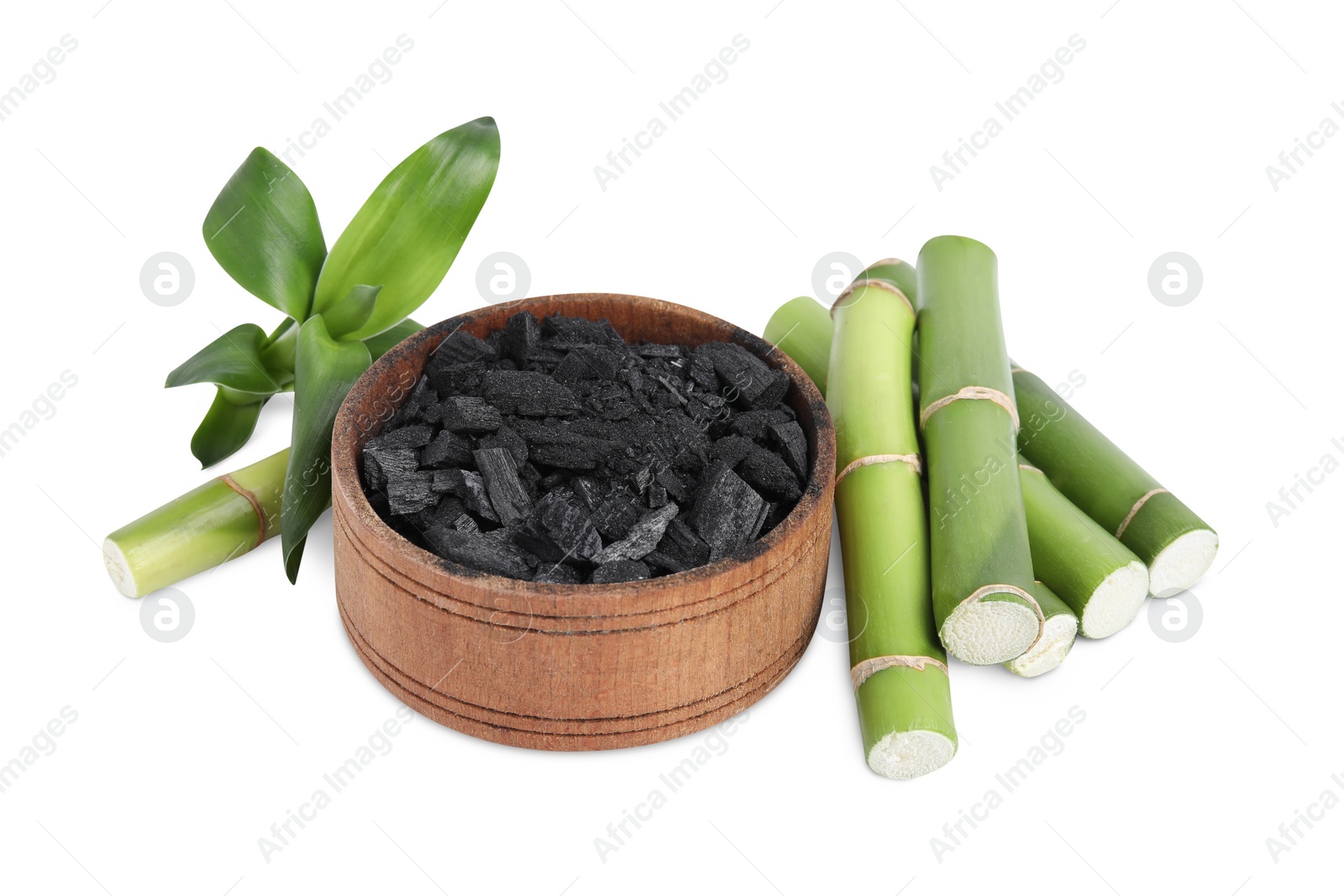 Photo of Fresh bamboo and charcoal on white background