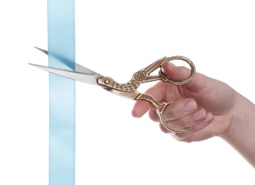 Photo of Woman cutting ribbon with beautiful scissors on white background, closeup