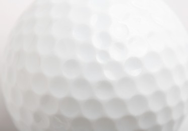 White golf ball as background, closeup view