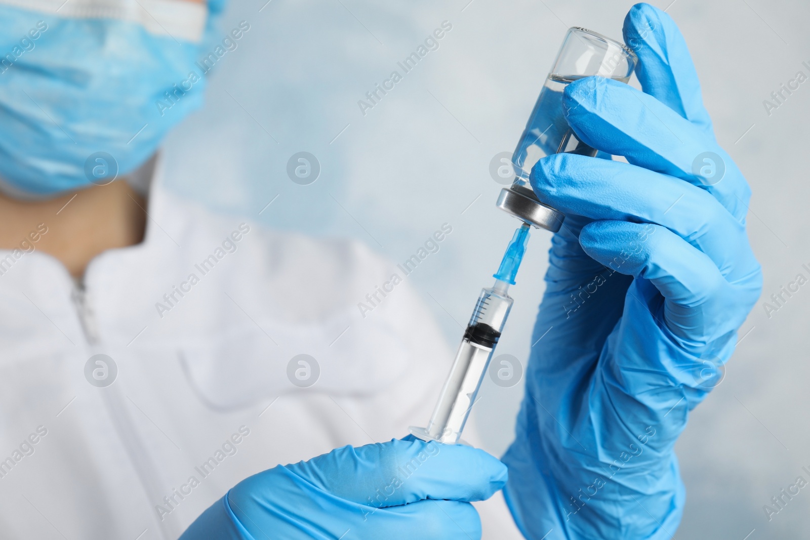 Photo of Doctor filling syringe with medication, closeup. Vaccination and immunization