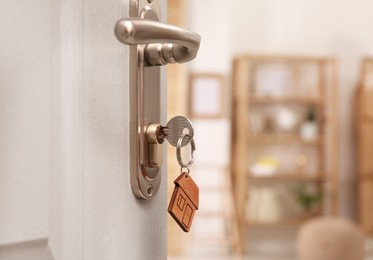 Open door with key in room, closeup