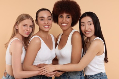 Portrait of beautiful young women on beige background