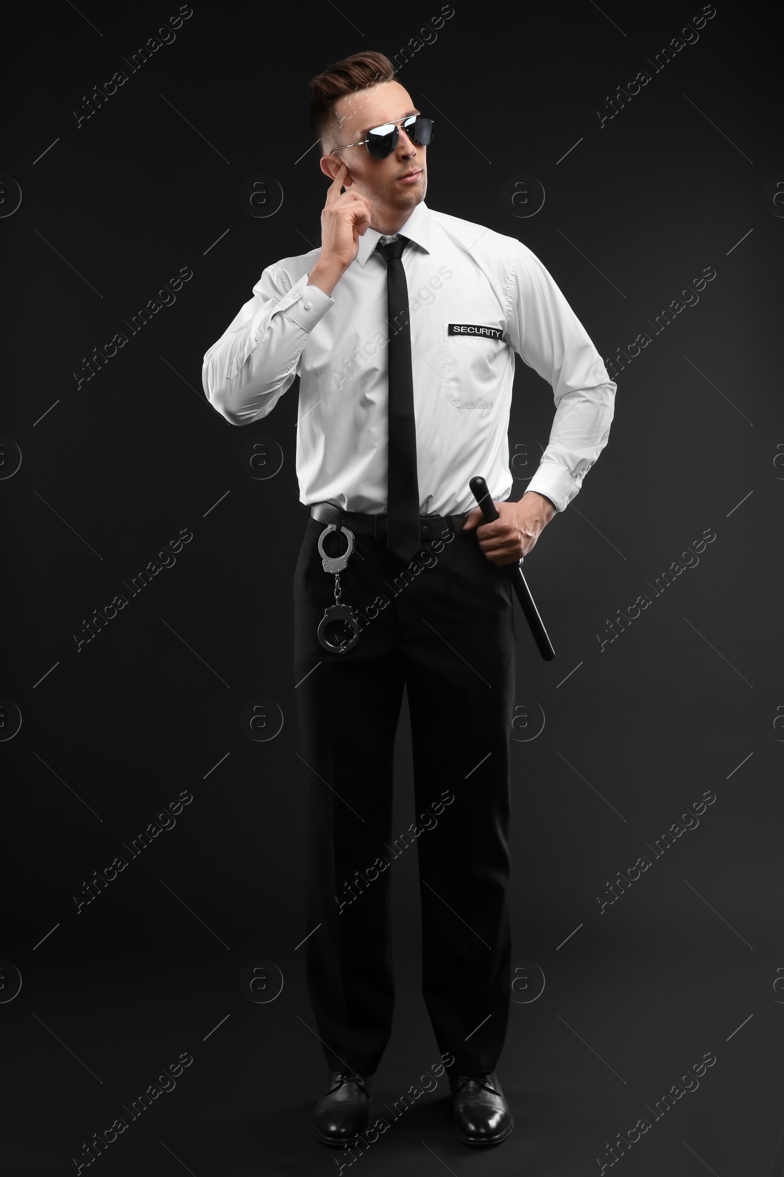 Photo of Male security guard in uniform on dark background