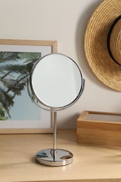 Photo of Mirror and picture on wooden table in room