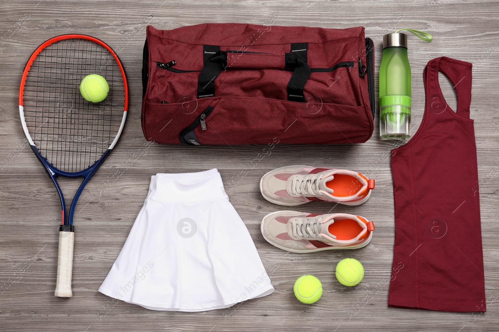 Photo of Sports bag and tennis equipment on wooden background, flat lay
